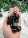 Jet Tumbled Stone, a glossy black fossilised wood for protection, grounding, grief support, emotional release, energy cleansing and stability.