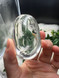 Shop this A Grade Clear Quartz Palmstone, featuring beautiful clarity and natural inclusions. A powerful crystal for focus, cleansing and energy amplification.