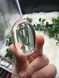Shop this A Grade Clear Quartz Palmstone, featuring beautiful clarity and natural inclusions. A powerful crystal for focus, cleansing and energy amplification.