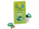 Dark chocolate peanut butter filled Easter eggs wrapped in green foils and packaged in a green, Easter themed gift box, with wrapped and unwrapped eggs sitting outside of the gift box. View Product Image