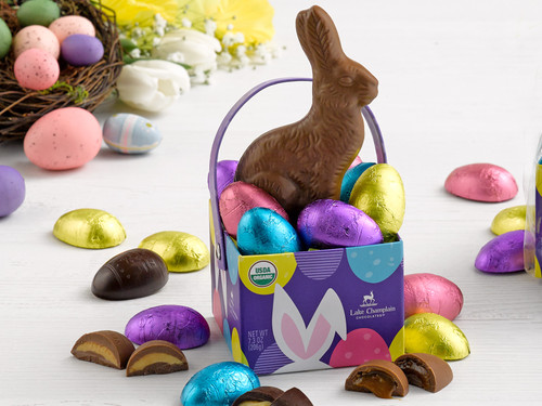 Milk chocolate Easter bunny in a paper box with chocolate eggs wrapped in colorful foils View Product Image