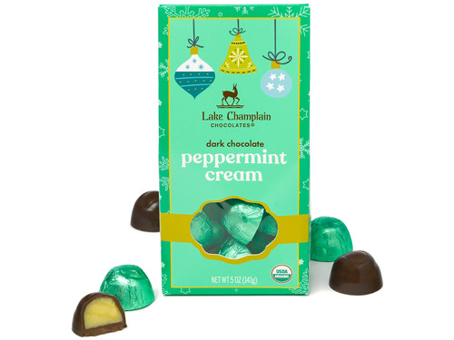 Dark chocolate mint cream filled jubilees wrapped in green foil and packaged in a green environmentally friendly gift box, with wrapped and unwrapped jubilees around the gift box. Dark chocolate mint cream filled jubilees wrapped in green foil and packaged in a green environmentally friendly gift box, with wrapped and unwrapped jubilees around the gift box.