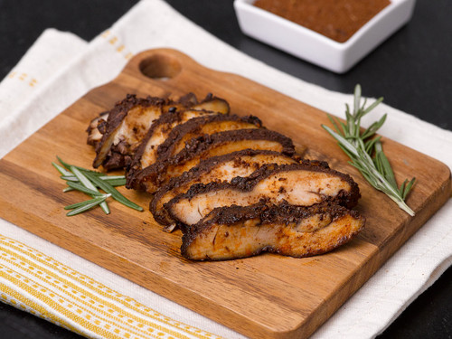 Chicken with a spicy homemade dry rub on a cutting board View Product Image