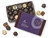 Brown gift box with a purplish-blue cover, filled with an assortment of 15 dark chocolates, with assorted chocolates around the outside of the gift box. View Product Image