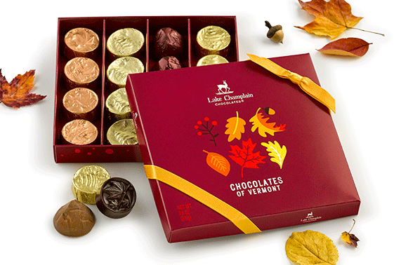 Assorted Chocolates of Vermont in an autumn theme gift box with yellow-gold ribbon on the cover of the gift box.