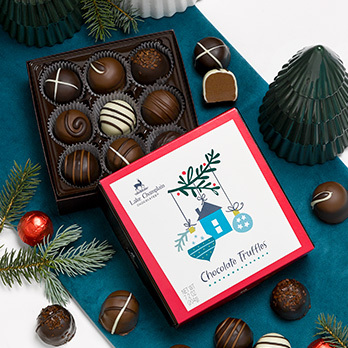 Assorted Chocolates of Vermont in an autumn theme gift box with yellow-gold ribbon on the cover of the gift box.