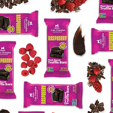 Plant-based raspberry truffle bars with raspberries and chocolate ingredients around the bars