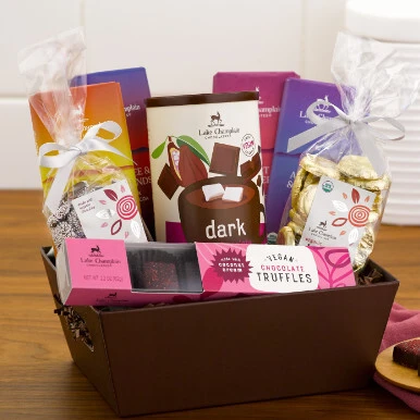 Assorted vegan chocolates in a reusable brown gift basket.