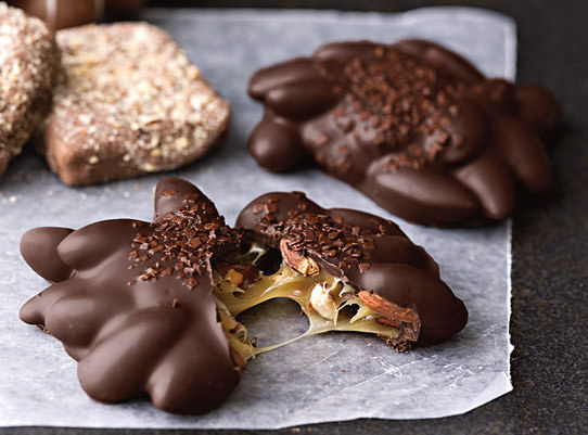 gooey almond caramel cluster covered in dark chocolate