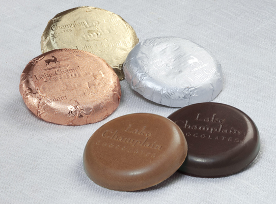 assorted milk and dark chocolate coins wrapped in foil and unwrapped