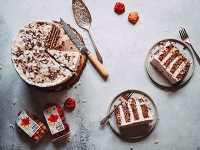 carrot cake slices on a plate with chocolate leaves