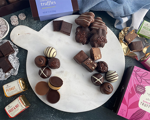 adding chocolates to dessert board