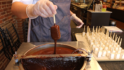 dipping marshmallows in dark chocolate