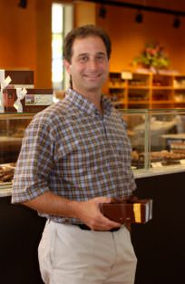 young Gary Coffey holding a box of chocolate