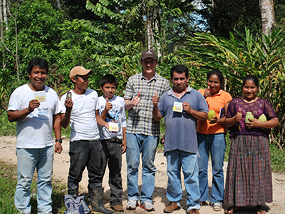 Eric Lampman giving chocolate bars to cocoa farmers in Guatemala