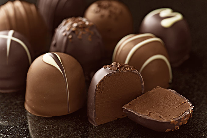 closeup of chocolate truffles on granite table