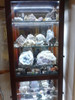 LED strip lighting installed inside glass display cabinet illuminating shelves and collectibles with warm white cabinet lighting