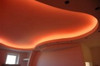 Red RGB LED strip lighting installed in curved ceiling bulkhead for decorative lighting effect