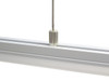 Suspended LED profile installed with hanging cables creating modern linear pendant lighting effect