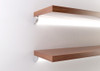 Corner LED profile installed on display cabinet shelves providing even LED strip lighting for glass shelving