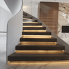 Under-step LED strip lighting creating floating staircase effect with warm illumination