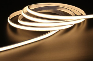 Close-up of LED strip inside silicone tube being inserted into an aluminium waterproof profile