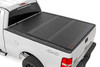 Rough Country's Hard Low-Profile Bed Cover is built for adventure. This tri-fold tonneau cover delivers a streamlined design that enhances your truck's off-road look while safeguarding your gear. Enjoy the peace of mind that comes with Rough Country's quality construction and easy access features. Here's what makes this tri-fold tonneau cover the ultimate winner:Low Profile, Sleek Look: Ditch the bulky covers! Our low-profile design seamlessly integrates with your truck bed, adding a touch of style without sacrificing function.Folds for Easy Access: Need to grab your gear in a hurry? No sweat! This tri-fold design lets you open the cover partially or fully in seconds, so you can access your truck bed whenever you need to.Extra Security: Worried about leaving your tools or weekend essentials behind? This cover integrates with your truck's tailgate lock, so you can relax knowing your gear is safe from prying eyes.Easy Does It Installation: We get it; you'd rather be out on the trails than wrestling with instructions. That's why our Bed Cover is designed for a simple, hassle-free installation. You'll be cruising with newfound bed security in no time!Built to Last: Rough Country backs this tonneau cover with a 5-Year Warranty, so you can rest assured it's ready to conquer any adventure.Streamline your truck bed, secure your gear, and hit the trails with peace of mind. Rough Country's Hard Low-Profile Bed Cover is the perfect solution for those who demand both style and functionality.