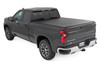 All-Weather Bed Protection: Rough Country's Soft Roll-Up Bed Cover delivers reliable protection against the elements while preserving full bed functionality. Constructed from high-quality, marine-grade vinyl with a sleek matte black finish, this durable cover features heavy-duty hook-and-loop side seals and tight front and rear barriers to shield your cargo from rain, dust, and debris.Streamlined Low-Profile Design: Sitting just 1-1/8" above the bed, this top-mount cover blends seamlessly with your truck's lines for a clean, stylish look. The corrosion-resistant, black powder-coated aluminum frame offers long-lasting strength without sacrificing style or aerodynamics.Fast and Easy Bed Access: The roll-up design and spring-latch closure system make opening and closing the cover a breeze. A single cable pull lets you release the latch quickly, giving you fast access to your full bed whenever you need it. Whether you're hauling gear or unloading tools, convenience comes standard.Effortless Installation: No drilling required - this cover installs in just 20 minutes using the included bracket system and tools. It mounts securely to your factory bed rails for a snug, hassle-free fit you can count on.Protected by a 5-Year Warranty: Rough Country backs this Soft Roll-Up Bed Cover with a 5-Year Replacement Warranty, protecting against structural and workmanship defects so you can hit the road with total confidence.