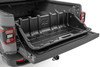 The days of having your cargo scattered all over your truck's bed have ended.  Rough Country's truck bed cargo box will keep your stuff organized and ready to access quickly.  You will appreciate the features of this unique storage box when it's time to unload a few groceries, boxed items, golf clubs, or whatever cargo you are hauling.  Just slide it out onto the tailgate for easy, frustration-free access.\
Cargo Management: Gain easy access with Rough Country's Truck Bed Cargo Storage Box.  This unique solution allows you to easily store, organize, and access the contents of your bedΓÇöno more items rolling around the bed of your truck.\
Durable Construction: Each Storage Box is constructed of durable polyethylene and features a strategic tie-down location on the top and bottom of the unit to keep items secure.  This must-have cargo box features a grab handle, allowing you to slide the tray onto your tailgate, making unloading and loading your gear a breeze.  Sitting 16.5" tall, this box will fit under a bed cover, making it the ultimate solution.\
Ready to use in minutes: Installation couldn't be easier.  Attach the two carabiner hooks to your existing tie-downs in your truck bed, secure the straps, and you're done!  It's also simple to remove if you need the extra space; unclip and slide to the side, or remove it altogether.\
3-Year Warranty: Rough Country's Storage Box has a three-year replacement warranty for manufacturer defects.  With our industry-leading guarantee, give yourself peace of mind when using Rough Country products!