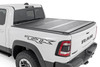 Rough Country's Hard Low-Profile Bed Cover is built for adventure. This tri-fold tonneau cover delivers a streamlined design that enhances your truck's off-road look while safeguarding your gear. Enjoy the peace of mind that comes with Rough Country's quality construction and easy access features. Here's what makes this tri-fold tonneau cover the ultimate winner:Low Profile, Sleek Look: Ditch the bulky covers! Our low-profile design seamlessly integrates with your truck bed, adding a touch of style without sacrificing function.Folds for Easy Access: Need to grab your gear in a hurry? No sweat! This tri-fold design lets you open the cover partially or fully in seconds, so you can access your truck bed whenever you need to.Extra Security: Worried about leaving your tools or weekend essentials behind? This cover integrates with your truck's tailgate lock, so you can relax knowing your gear is safe from prying eyes.Easy Does It Installation: We get it; you'd rather be out on the trails than wrestling with instructions. That's why our Bed Cover is designed for a simple, hassle-free installation. You'll be cruising with newfound bed security in no time!Built to Last: Rough Country backs this tonneau cover with a 5-Year Warranty, so you can rest assured it's ready to conquer any adventure.Streamline your truck bed, secure your gear, and hit the trails with peace of mind. Rough Country's Hard Low-Profile Bed Cover is the perfect solution for those who demand both style and functionality.