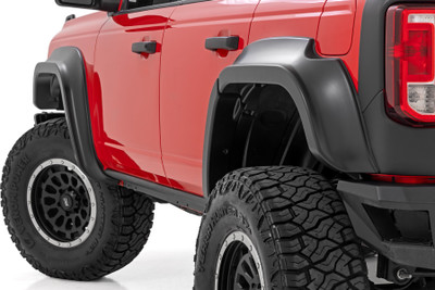 Bold Style & Extra Coverage: Give your Ford Bronco a commanding presence on and off the road with Rough CountryΓÇÖs Fender Flares. Designed to enhance your BroncoΓÇÖs rugged appeal, these flares provide increased tire coverage to help shield your ride from mud, rocks, and road debris. Whether you're tackling tough trails or cruising through the city, these aggressively styled fender flares ensure your Bronco stands out from the crowd.Built for Durability: Engineered with everyday adventurers in mind, Rough Country Fender Flares are crafted from a high-strength Tri-Blend ABS material that delivers exceptional toughness without adding unnecessary weight. The UV-protected finish resists fading, ensuring your BroncoΓÇÖs flares maintain their bold look for years to come. Plus, the smooth surface allows for easy painting, so you can match them to your BroncoΓÇÖs color for a factory-style finish.Hassle-Free Installation & Warranty: Featuring a no-drill design, these fender flares install quickly and securely, getting you back on the road in no time. Need to return to stock? They can be easily removed without any hassle. Backed by Rough CountryΓÇÖs 3-year limited warranty, you can trust these fender flares to deliver the quality and protection your Bronco deserves.