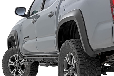 Style and Protection. Unlock the power of real protection and custom style with Rough Country's Sport Style Fender Flares for your Toyota Tacoma! Offering 5.75 inches of Flare Height, you know your truck is getting the coverage it needs from flying debris and road grime. Not only will these flares safeguard your vehicle, but they will look great too - featuring a bold custom look that stands out and turns heads. Plus, if you want to take your customization game up a notch, these fender flares are easily paintable so they can match your truck in color and style. Get ready to rock this new rugged look ΓÇô with Rough Country's Tacoma Sport Style Fender Flares!\
Sturdy Construction. These bold and rugged fender flares are designed exclusively for third-generation Toyota Tacoma owners, creating an instant upgrade for your ride. Made from a special Tri-Blend ABS material, these flares have maximum strength and durability, ensuring they will stand up to the toughest conditions that nature has to offer. For added protection, each fender is machine-formed to exact specifications with a high-grade UV protection. Not only do these fender flares look great, but you can trust that they will hold up and continue looking fresh despite the elements.\
Installation and Warranty. Featuring an easy and quick installation process, these flares have been designed to provide your truck with the stylish look you've been searching for without any of the hassle. Plus, if you need to bring your truck back to its original specs, the flares can be removed in a flash! But that's not all ΓÇô each set comes equipped with a three-year limited warranty. Stop dreaming about that showroom-level look and make it happen with Rough Country's Tacoma Sport Style Fender Flares.