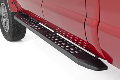Elevate your style. Add a touch of the wild to your ride with Rough Country's Raptor-inspired running board side steps! Made from durable, rust-resistant steel, they feature a slimmer design that looks great on lifted vehicles. And if that's not enough, we've added dimple die holes for extra traction - ensuring you'll be safe and stable when stepping onto your running boards.Steady and Stylish. Our RPT2 running boards feature a 6.75-inch wide stepping area, perfect for getting in and out of your cab with ease. Plus, they're coated in matte black powder for a sleek, finished look. And if you're worried about safety, don't be! Our non-slip design ensures that you'll stay steady on your feet. Plus, the one-piece steel construction ensures that these steps will last for years to come.Installation. These side steps are a must-have for anyone looking to make their Chevy/GMC stand out from the crowd. With an easy installation that doesn't require any drilling or cutting, these running boards can be installed at home in just 1-2 hours. Transform your truck with Rough Country's RPT2 Running Board Side Steps.Warranty. Rough Country's Running Board Side Steps are backed with a five-year replacement warranty towards manufacturer defects. As such, the product is protected from structural and workmanship damage after the date of purchase. With our industry-leading warranty, give yourself peace of mind when using Rough Country's products!