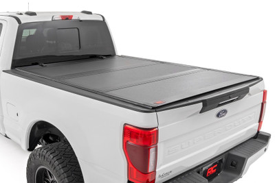 Elevate your Super Duty's functionality and appearance with Rough Country's Ford Super Duty Hard Tri-fold Flip-up Bed Cover. Unlike traditional bed covers that limit access to your truck bed, our innovative Flip-up design grants you complete access to your truck bed, making it easier to load and unload large items.\
Full-Bed Access: With Rough Country's Tri-fold Flip-up Bed Cover, you can conveniently flip up the cover, allowing full-bed access without the hassle of removing the cover.\
Built to Last: Our bed cover is crafted from lightweight aluminum and boasts a resilient powder coat finish. This coating resists corrosion and wear, ensuring that your truck bed maintains its pristine appearance even in harsh weather conditions.\
Superior Water Drainage System: The bed rails of this bed cover feature an innovative water drainage system. No need to worry about water pooling on your cover or seeping into your truck bed.\
Premium Weather Seals: The Tri-fold cover also includes top-of-the-line weather-resistant seals that create a tight and secure barrier along the bed rails. These seals ensure your cargo remains protected from the elements, even in inclement weather.\
Secure Cargo Storage: Provide added security for your truck bed contents, deterring theft and protecting valuable items.\
Elevate your F-250/350ΓÇÖs truck bed and get full access, unmatched durability, and superior weather protection with Rough Country's Hard Tri-fold Flip-up Bed Cover!