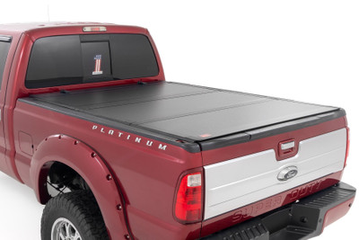 Elevate your Super Duty's functionality and appearance with Rough Country's Ford Super Duty Hard Tri-fold Flip-up Bed Cover. Unlike traditional bed covers that limit access to your truck bed, our innovative Flip-up design grants you complete access to your truck bed, making it easier to load and unload large items.\
Full-Bed Access: With Rough Country's Tri-fold Flip-up Bed Cover, you can conveniently flip up the cover, allowing full-bed access without the hassle of removing the cover.\
Built to Last: Our bed cover is crafted from lightweight aluminum and boasts a resilient powder coat finish. This coating resists corrosion and wear, ensuring that your truck bed maintains its pristine appearance even in harsh weather conditions.\
Superior Water Drainage System: The bed rails of this bed cover feature an innovative water drainage system. No need to worry about water pooling on your cover or seeping into your truck bed.\
Premium Weather Seals: The Tri-fold cover also includes top-of-the-line weather-resistant seals that create a tight and secure barrier along the bed rails. These seals ensure your cargo remains protected from the elements, even in inclement weather.\
Secure Cargo Storage: Provide added security for your truck bed contents, deterring theft and protecting valuable items.\
Elevate your F-250/350ΓÇÖs truck bed and get full access, unmatched durability, and superior weather protection with Rough Country's Hard Tri-fold Flip-up Bed Cover!