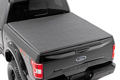 Want to streamline your ride and protect your gear from the elements? Look no further than Rough Country's Tri-Fold Vinyl Tonneau Cover! With its durable construction and easy installation, it's the perfect addition to any truck.Tri-fold Design for Style and Efficiency: This tonneau cover folds up in three sections for easy access to your bed whenever you need it. Need to haul a large item? Simply fold back a panel. When everything's loaded up, unfold it completely for a sleek look that can also improve your gas mileage.Security & Weatherproof Seal: Sitting firmly on the bed railing and featuring a heavy-duty vinyl construction with an all-weather seal, our tri-fold cover keeps your gear safe from prying eyes and the elements.Durable Construction: Crafted with a lightweight 6061 aluminum frame, this cover is tough enough to handle whatever rough terrain you throw at it while keeping your gear safe and sound.Effortless Installation: Our cover comes completely assembled in the box, no loose parts, no tools required. Thanks to our patented quick clamp system, you'll be ready to hit the road in no time.Protect your gear and streamline your ride with Rough Country's Tri-Fold Vinyl Tonneau Cover!