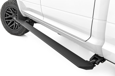 Step Up with Confidence: Rough Country's Power Running Boards are the next evolution in vehicle access, blending rugged functionality with sleek styling. These electric, retractable E-Boards automatically extend when the door opens and tuck tight against the body when closed, delivering a clean, low-profile look. A textured, anti-slip coating ensures a firm grip in any weather, while integrated LED lights illuminate the step area for safe entry and exit, day or night.Built to Handle It All: Crafted from lightweight yet tough 6" aluminum, these all-season steps are made to withstand the elements and daily use. Each board supports up to 660 lbs. per side, making them ideal for work, play, or overland adventures. Dual-motor technology guarantees smooth and dependable movement, while the automatic 'SAFE-STOP' safety feature halts operation if an obstruction is detected. A built-in interior bypass switch gives you manual control whenever you need it.Protection with Purpose: When retracted, the E-Boards sit tight against the rocker panel, acting as a protective barrier against rocks and debris while enhancing your ride's streamlined appearance. Whether you're navigating city streets or backcountry trails, these steps add functionality and defense in one smart package.Simplified Installation: Rough Country makes installation straightforward with a bolt-on design and included hardware. While minor drilling is required, you'll get a secure, factory-style fit that blends seamlessly with your vehicle.Peace of Mind Guaranteed: Every set of Power Running Boards is backed by Rough Country's 5-year limited replacement warranty, covering structural and workmanship defects. Trust in proven durability and ride with confidence.