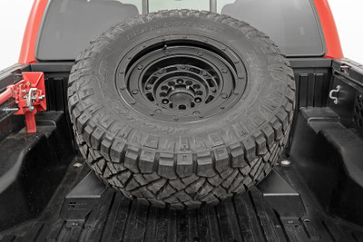 Easy Access. When you're on an off-roading adventure, you don't want to waste time trying to find your spare tire when the unexpected happens. Our Bed Mount Spare Tire Carrier makes it easy to access your extra tire when you need it the most. This sturdy and solid spare tire holder can securely hold up to a 40-inch tire in your bed, giving you easy access to a full-sized spare anytime you need it.Durable Construction. Constructed of durable steel, our bed mount tire carrier is the ultimate way to mount a spare tire prominently in your truck bed. It features a high-quality powder coat finish that offers chip resistance and corrosion resistance and has rubber gaskets to protect your bed from scrapes and scuffs. Installing the carrier will be a snap with our easy-to-follow instructions and some drilling required. It's also covered by Rough Country's Limited Lifetime Warranty, so you know it's built to last.