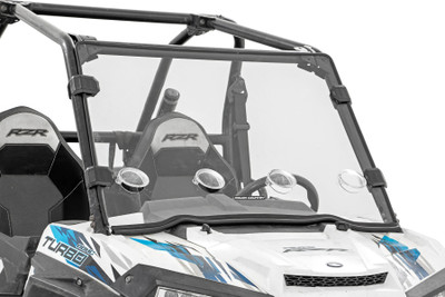 Added Protection and Customizable Comfort: Shield the occupants of your Polaris RZR from off-road hazards like rocks, branches, and debris with Rough Country's Scratch-Resistant Windshield. This innovative design combines protection with unmatched comfort by featuring 4 adjustable vents that allow you to control airflow to suit your needs. Vents can be closed, opened, or half-opened for ultimate versatility. Whether you're navigating dusty trails or keeping cool on hot days, the 360┬░ rotating vents provide superior flexibility, making every ride more enjoyable. High-Quality Polycarbonate Construction: Crafted from thick .25 polycarbonate material, Rough Country windshields deliver the ultimate combination of clarity, flexibility, and durability. Precision cut for a flawless fit, this material outperforms glass and acrylic in toughness, ensuring your windshield can handle even the roughest terrains. Enhanced Durability with Scratch and UV Resistance: Each windshield is coated with a secondary AR2 hard-coating process, creating a robust scratch-resistant barrier that extends its lifespan. This treatment also provides UV protection, ensuring your windshield remains clear and functional for years to come. Contoured Design with a Precision Fit: The contoured design and premium rubber seal ensure a secure, rattle-free fit that keeps out dust, debris, and water, while seamlessly complementing the rugged aesthetics of your Polaris RZR. Seamless Roof Compatibility: Engineered to integrate effortlessly with both factory and most aftermarket roofs, this windshield adds versatility without compromising style or functionality. Quick and Easy Installation: With a simple strap-on installation process, you can have your Rough Country windshield ready to go in as little as 15ΓÇô30 minutes. Spend less time prepping and more time conquering the trails. Limited-Lifetime Replacement Warranty: Rough Country stands behind its products with a limited lifetime replacement warranty against manufacturer defects. Ride with confidence knowing your windshield is protected from structural or workmanship damage.