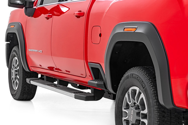 Style and Protection: Give your fifth-generation GMC Sierra 2500 HD/3500 HD a bold, aggressive look while keeping it protected with Rough Country's Sport Style Fender Flares! With 6.5 inches of flare height and 1 inch of extra coverage, these flares provide superior defense against road debris, mud, and grime. The sleek flat black finish delivers a rugged off-road aesthetic, but if you want a custom touch, they're easily paintable to match your truck's color and style. Whether you're hitting the trails or cruising the streets, these fender flares will make sure your Sierra stands out from the crowd.Durable and Built to Last: Designed for maximum strength and longevity, these fender flares are constructed from Tri-Blend ABS material, making them tough enough to withstand the harshest conditions. Each flare is UV-protected to prevent fading, ensuring they maintain their fresh, aggressive look over time. Plus, their precision-engineered fitment means they hug your truck's body perfectly, giving you the protection and style you need without compromise.Easy Installation and Warranty: Get the upgraded look you want without the hassle! These flares offer a quick and easy bolt-on installation with no drilling required, making the process smooth and stress-free. Want to return your truck to stock? The flares can be removed just as easily! Plus, every set is backed by Rough Country's 3-year limited warranty, so you can drive with confidence knowing your investment is protected. Stop waiting-upgrade your Sierra today with Rough Country's Sport Style Fender Flares!