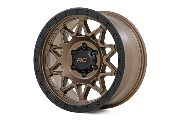 Take your off-road rig to the next level with a wheel designed for adventure and built to perform. The Rough Country 78 Series wheel combines bold aesthetics with rugged functionality, making it the ultimate choice for off-road enthusiasts. Bold Bronze Finish with Black Lip: Striking contrast that enhances your vehicle's aggressive, trail-ready look. Simulated Beadlock Design: Gives your rig that hardcore off-road styling while maintaining easy installation. Unmatched Strength & Lightweight Performance: Precision-engineered from a single piece of premium aluminum for unbeatable durability without adding extra weight. Premium Details: Includes a Rough Country black center cap with standout bronze lettering for a clean, custom touch. Trail-Tested Durability: Backed by a 1-year finish warranty and a Limited Lifetime Structural Warranty to handle whatever the trails throw your way. Whether you're tackling rugged terrain or just want to stand out from the crowd, these wheels are built to deliver. Gear up and conquer the trails in style with Rough Country!