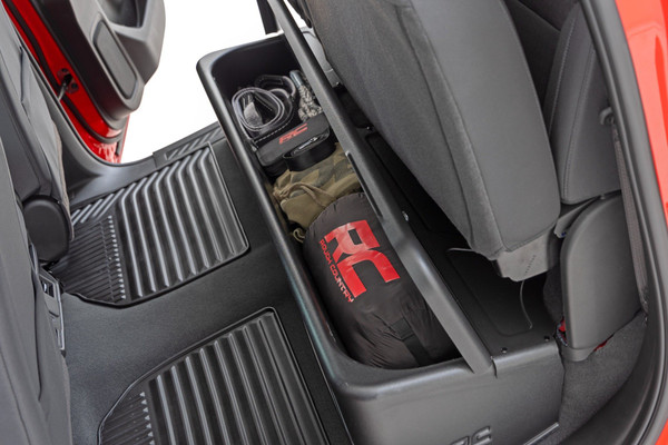 Clean up the contents of your cab with Rough CountryΓÇÖs Custom-Fit Under Seat Storage Compartment. These handy underseat truck storage compartments offer an easy way to store your gear with a custom, contoured look that blends in seamlessly with your vehicleΓÇÖs factory design. Keep your tools, gear, and other odds and ends organized and stowed away while conveniently stowed away under the rear seats.\
Each under-seat storage tray is constructed from a durable, high-density thermoplastic material thatΓÇÖs built to withstand kicks, nicks, and corrosion. A convenient anti-skid surface helps prevent the contents of your underseat cargo tray from rolling around while driving. Best of all, Rough CountryΓÇÖs Custom-Fit Under Seat Storage Compartments are easy to install, so you can upgrade your cargo management quickly and easily!