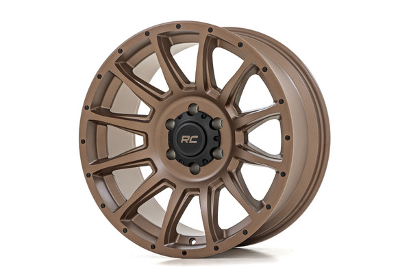 If you've been hitting the trails and feeling like your wheels just aren't cutting it, then itΓÇÖs time to upgrade your wheels.  Designed for hardcore off-roaders and weekend warriors alike, Rough CountryΓÇÖs 90 Series Wheel solves the problem of having to choose between strength, style, and performance. With the 90 Series, you get it all.Distinctive Bronze Finish: Stand out on the trails and turn heads at every stoplight with our eye-catching bronze finish. Not only does it look slick, but itΓÇÖs also built to resist the elements.Single-Piece Aluminum Construction: Engineered with cutting-edge aluminum, the 90 Series boasts an industry-leading strength-to-weight ratio. This translates to a lighter ride for your vehicle and exceptional durability, ensuring you can handle even the most rugged terrain with confidence.Multi-Spoke Design: The sleek multi-spoke design adds a touch of class to your ride and provides superior strength and durability so you can conquer the trails in style without sacrificing performance.Rough Country Black Center Cap: Every wheel includes a Rough Country black center cap, adding a subtle yet bold touch to your setup.Warranty Coverage: Ride with confidence, knowing you're backed by a 1-year finish warranty and a Limited Lifetime Structural Warranty. WeΓÇÖve got your back so you can focus on the adventure ahead.The 90 Series Wheel is more than just a tool for conquering trails. It's a statement of style and a symbol of your off-road prowess. Whether youΓÇÖre navigating rocky terrains or splashing through mud, this wheel is designed to perform and impress. It's time to leave the mundane behind, embrace the thrill of adventure, and transform your ride into an off-road legend.