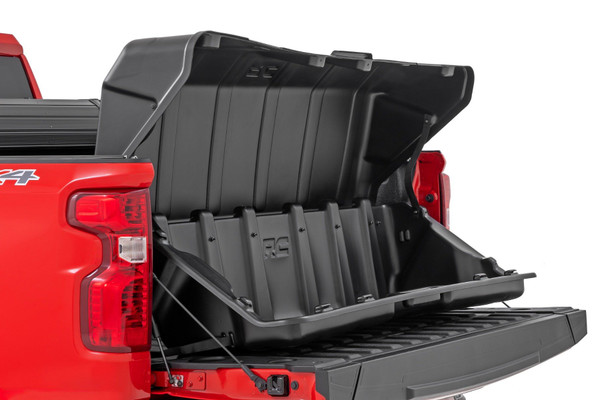 The days of having your cargo scattered all over your truck's bed have ended.  Rough Country's truck bed cargo box will keep your stuff organized and ready to access quickly.  You will appreciate the features of this unique storage box when it's time to unload a few groceries, boxed items, golf clubs, or whatever cargo you are hauling.  Just slide it out onto the tailgate for easy, frustration-free access.Cargo Management: Gain easy access with Rough Country's Truck Bed Cargo Storage Box.  This unique solution allows you to easily store, organize, and access the contents of your bedΓÇöno more items rolling around the bed of your truck.Durable Construction: Each Storage Box is constructed of durable polyethylene and features a strategic tie-down location on the top and bottom of the unit to keep items secure.  This must-have cargo box features a grab handle, allowing you to slide the tray onto your tailgate, making unloading and loading your gear a breeze.  Sitting 16.5" tall, this box will fit under a bed cover, making it the ultimate solution.Ready to use in minutes: Installation couldn't be easier.  Attach the two carabiner hooks to your existing tie-downs in your truck bed, secure the straps, and you're done!  It's also simple to remove if you need the extra space; unclip and slide to the side, or remove it altogether.3-Year Warranty: Rough Country's Storage Box has a three-year replacement warranty for manufacturer defects.  With our industry-leading guarantee, give yourself peace of mind when using Rough Country products!