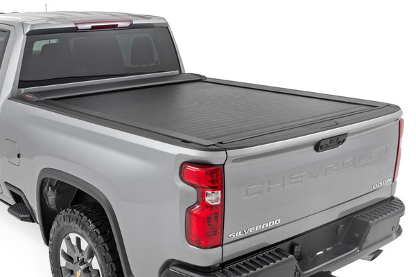 Superior Protection and Functionality. Protect your bed from weather and add security with Rough CountryΓÇÖs sleek Retractable Bed Covers. Boasting a weather-resistant vinyl covering over a rigid aluminum panel design Rough Country's Retractable Covers sit firmly on the bed rails allowing for full rear visibility. These durable bed covers feature a flush, low-profile design that gives your truck a clean, sleek look while protecting the contents of your bed.\
Innovative Design. Each cover features a premium, matte black finish for uncompromised protection and killer good looks. The convenient retractable design allows easy access to your bed and the ability to haul large items without entirely removing the cover. Simply utilize the pull strap to retract the cover to gain access to your bed! This cover features a full-width handle that allows you to open or close the cover from either side of the bed. Each cover offers a tension spring that helps the cover retract smoothly and easily in seconds!┬á\\
Installation.┬áWith a 100% bolt-on installation process, installation couldn't be easier. With an estimated timeframe of 1-2 hours, this cover can be installed at home using standard tools and can be completed efficiently and quickly!\
Five Year Warranty. Rough Country's Retractable Bed Covers are backed with a five-year warranty towards manufacturer defects. As such, the product is protected from structural and workmanship damage after the date of purchase. With our industry-leading warranty give yourself peace of mind when using Rough Country's Suspension products!