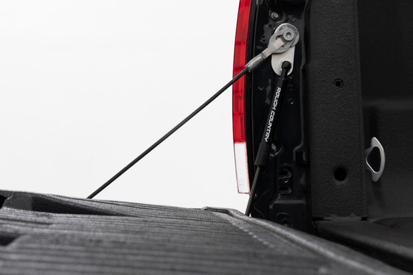 This Assistance You Need. Want a hassle-free way of lowering your tailgate? Look no further than Rough Country's Ford Super Duty Tailgate Assist! Simply grab and pull the handle, and your gate will ease down, making accessing the back of your truck effortless. With this smooth device, you'll never have to worry about your truck's tailgate slamming down suddenly.  Plus, it provides a safe way to lower your tailgate without straining or using two hands. With Rough Country's revolutionary technology, you can make operating your tailgate as smooth as can be.\
Installation and Warranty. This easy-to-install tailgate assistant works with your factory cables to provide effortless, safe opening and closing ΓÇôgiving you a smooth ride every time. With only one tailgate assist required per truck, you can hit the road and move on in no time. Our Tailgate Assist fits directly onto your driver side without having to drill any holes, and all the hardware you need to install is included in the package. Custom Designed specifically for the Ford Super Duty, Rough Country's Tailgate Assist is back with a three-year warranty!