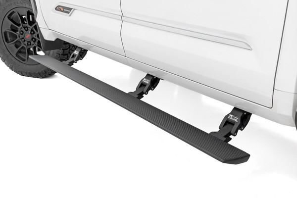 Step up in style.ΓÇ»Sidesteps have come a long way, and now we've taken them to the next level with Rough Country'sΓÇ»Power Running Boards! These retractable E-Boards tuck tightΓÇ»for a clean look when not in use and automatically extend when the door is opened. With an anti-slip surface that provides a secure stepping area, getting in and out of your ride has never been easier.ΓÇ»Our Power Running Boards alsoΓÇ»include LED lights that provide illumination when deployed and shut off when steps are closed, providing a sleek, aerodynamic look.\
ΓÇ»Premium Construction. The Rough Country E-Board Steps combine durability, strength, and style. These 6" all-season steps are made from lightweight yet durable aluminum and can support up to 660 lbs per side. Equipped with dual motor technology, these steps can handle anything Mother Nature throws their way. They feature an automatic 'SAFE-STOP' mechanism that engages if a blockage is detected and include an interior bypass switch for manual override. So whether you're heading out on a weekend errand or loading up for a camping trip, our electric steps offer reliable protection for all your adventures.\
Installation.ΓÇ»These easy-to-install steps are the perfect solution for getting in and out of your vehicle. No drilling is required for installation, and the steps tuck tight under the rocker panelΓÇ»when not in use. Don't struggle to get in and out of your vehicle anymore. Make life easier with Rough Country's Power Running Boards.\
Warranty. Rough Country backs its products with a five-year limited replacement warranty. Our products are protected from structural and workmanship damage after purchase. Our industry-leading warranty gives you peace of mind when using Rough Country products!