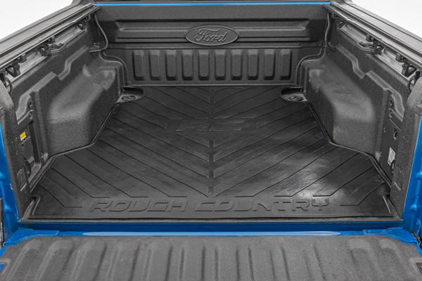 Innovative Design and Material. Keep your truck bed free from scuffs, scrapes, and scratches with Rough Country Truck Bed Mats. These heavy-duty, 3/8-inch thick, contoured rubber mats are nearly indestructible; made from a high-quality rubber compound that wonΓÇÖt crack in extreme temperatures or fade when exposed to the sun. This stylized bed mat features a large "RC" and "Rough Country" logo with angled lines for an improved look that also protects your truck bed.\
Installation. With a simple drop-in design, installation couldn't be easier. With an estimated timeframe of 10 minutes, this mat can be installed at home efficiently and quickly! Simply place the bed mat in, and roll it out and you're done!\
Limited Lifetime Replacement Warranty. Rough Country's bed mats are backed with a limited lifetime replacement warranty towards manufacturer defects. As such, the product is protected from structural and workmanship damage after the date of purchase. With our industry-leading warranty give yourself peace of mind when using Rough Country products!┬á