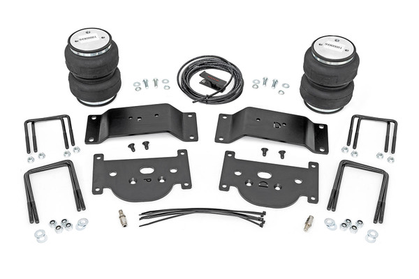 Ideal Leveling: Is your truck your workhorse? The main attraction of a pickup is the ability to haul and tow as needed. However, due to the weight in the bed or the condition of the rear leaf springs, your vehicle may become un-level under load. At Rough Country, we've designed a solution to eliminate these concerns. Introducing Rough Country's Rear Air Spring Kit.Heavy-Duty Construction: Rough Country's Rear Air Spring Kit includes two high-quality, double convoluted air bags, reinforced with durable powder-coated steel brackets and DOT-approved airlines. Whether you're towing a trailer or hauling heavy loads, this kit helps ensure your vehicle remains level, alleviating the strain on your trailer's tongue weight. The kit features 1/4" push-to-connect air fittings for easy installation, along with all necessary bracketry for a secure fit. Rough Country's Air Spring Kit supports up to 5,000 lbs of load, minimizing sway and preventing bottoming out while braking and steering.Easy Installation: Quick and simple setup for immediate use. Rough Country's kit can be installed at home with standard tools in just 5-6 hours, ensuring minimal downtime and fast, hassle-free installation.Onboard Air Compressor and Wireless Controller: For added convenience, Rough Country offers an optional onboard air compressor and wireless controller to easily adjust your air spring kit on the go. Control air pressure at the push of a button from the comfort of your vehicle.Reliable Warranty Coverage: Rough Country's Rear Air Spring Kit includes a limited lifetime warranty on the air springs and a two-year replacement warranty on the compressor, offering lasting protection against manufacturer defects. This industry-leading coverage ensures confidence in both quality and durability, so you can count on Rough Country to keep your truck performing at its best.