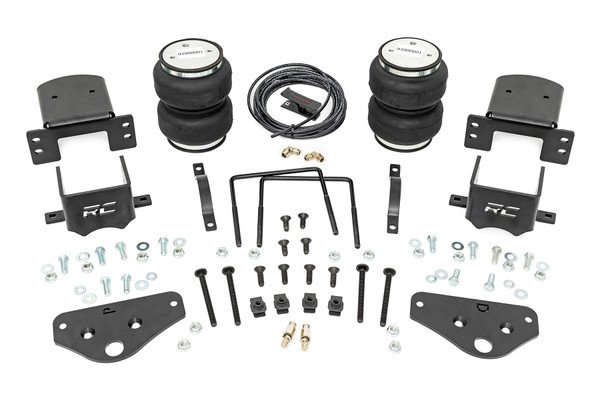 Ideal Leveling: Is your truck your workhorse? The main attraction of a pickup is the ability to haul and tow as needed. However, due to the weight in the bed or the condition of the rear leaf springs, your vehicle may become un-level under load. At Rough Country, we've designed a solution to eliminate these concerns. Introducing Rough Country's Rear Air Spring Kit.Heavy-Duty Construction: Rough Country's Rear Air Spring Kit includes two high-quality, double convoluted air bags, reinforced with durable powder-coated steel brackets and DOT-approved airlines. Whether you're towing a trailer or hauling heavy loads, this kit helps ensure your vehicle remains level, alleviating the strain on your trailer's tongue weight. The kit features 1/4" push-to-connect air fittings for easy installation, along with all necessary bracketry for a secure fit. Rough Country's Air Spring Kit supports up to 5,000 lbs of load, minimizing sway and preventing bottoming out while braking and steering.Easy Installation: Quick and simple setup for immediate use. Rough Country's kit can be installed at home with standard tools in just 5-6 hours, ensuring minimal downtime and fast, hassle-free installation.Onboard Air Compressor and Wireless Controller: For added convenience, Rough Country offers an optional onboard air compressor and wireless controller to easily adjust your air spring kit on the go. Control air pressure at the push of a button from the comfort of your vehicle.Reliable Warranty Coverage: Rough Country's Rear Air Spring Kit includes a limited lifetime warranty on the air springs and a two-year replacement warranty on the compressor, offering lasting protection against manufacturer defects. This industry-leading coverage ensures confidence in both quality and durability, so you can count on Rough Country to keep your truck performing at its best.